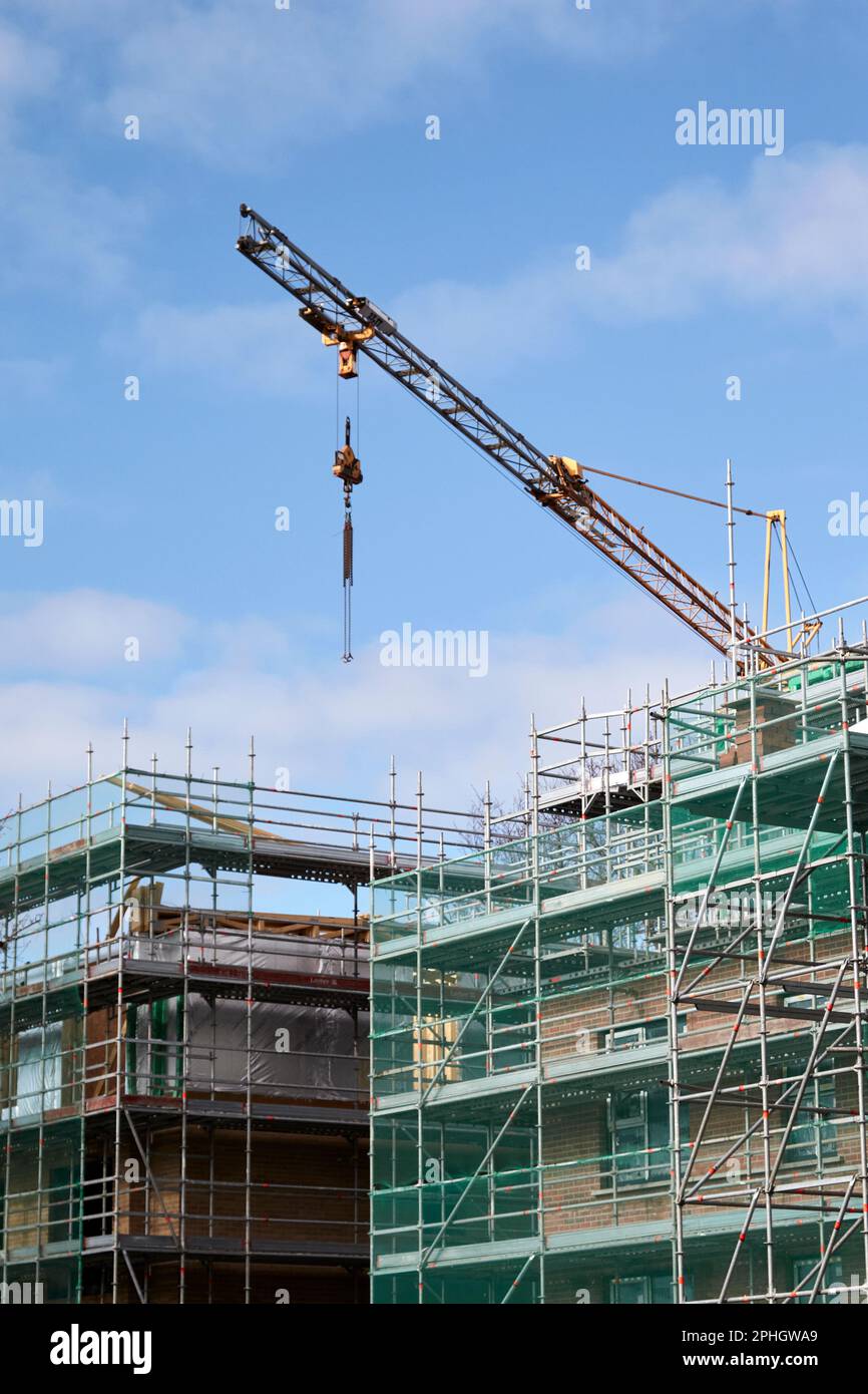 crane scaffolding and safety nets on construction site building new social housing block strandtown, east belfast, northern ireland, uk Stock Photo