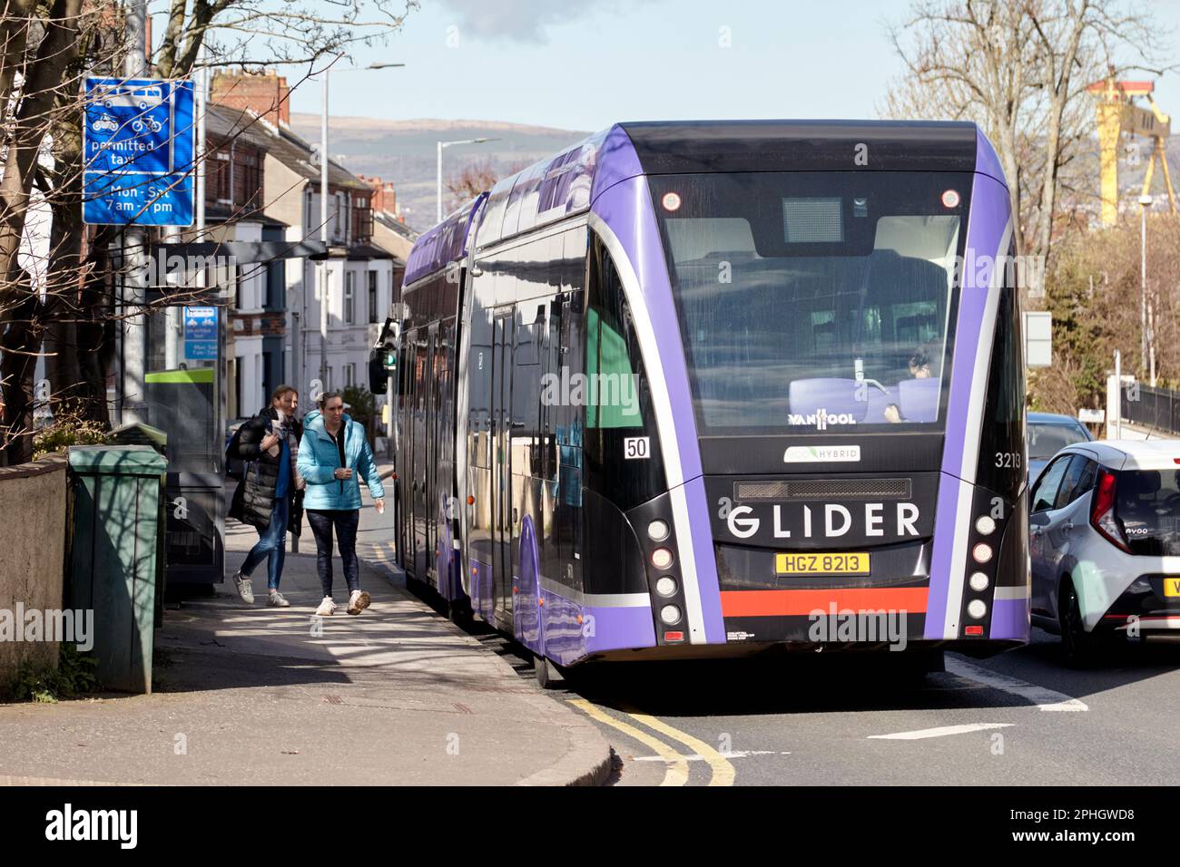 two female passengers about to board the glider bus into belfast