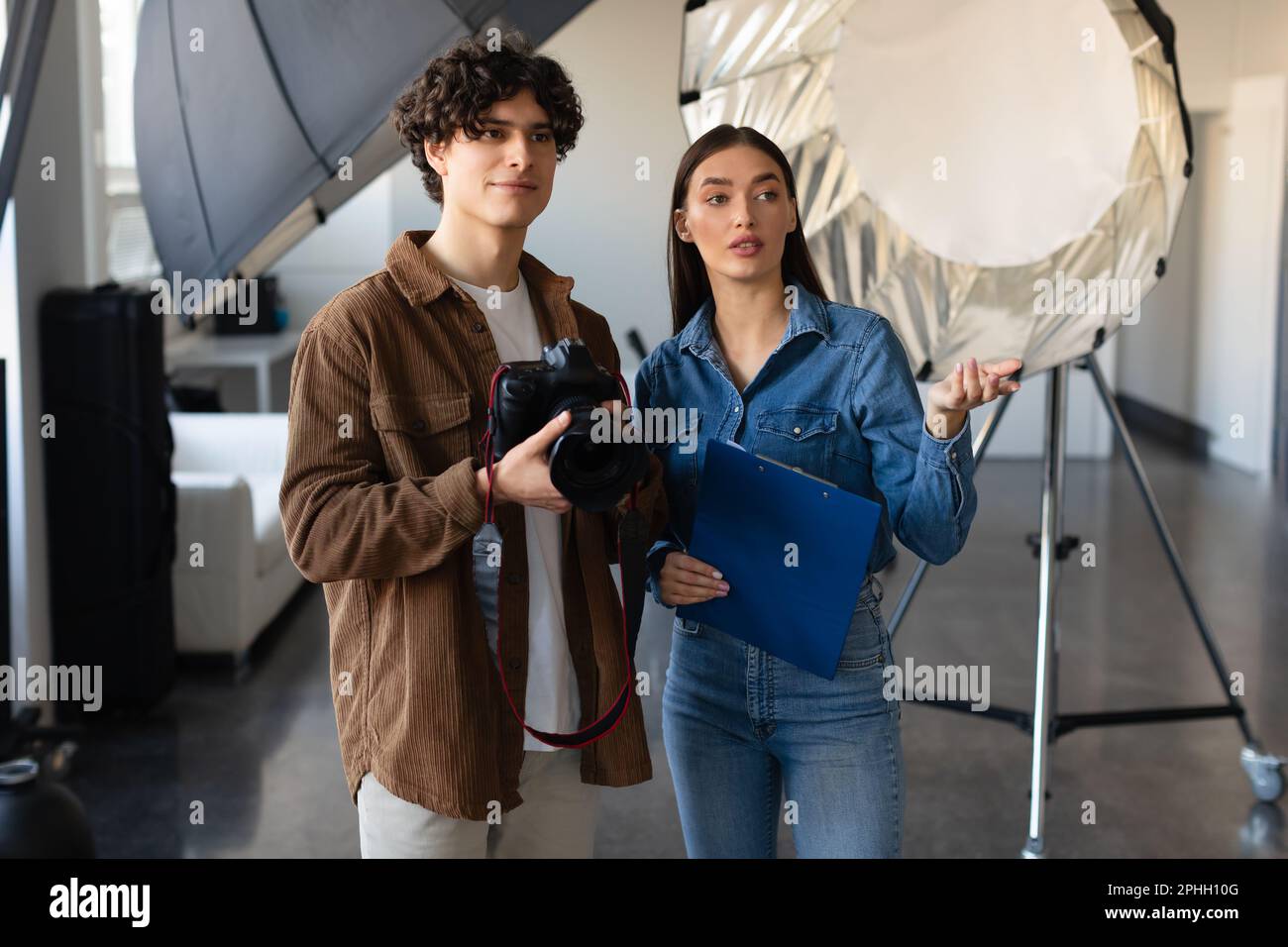 Female art director explaining photographer about the photoshoot