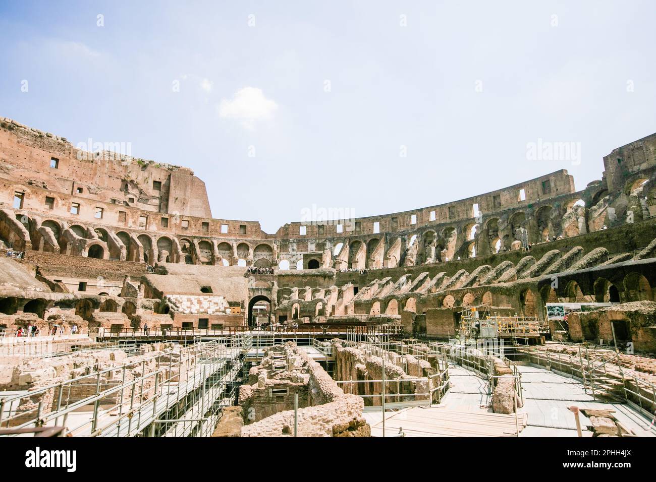 An expansive view of the inner part of the Colosseum on a sunny day ...