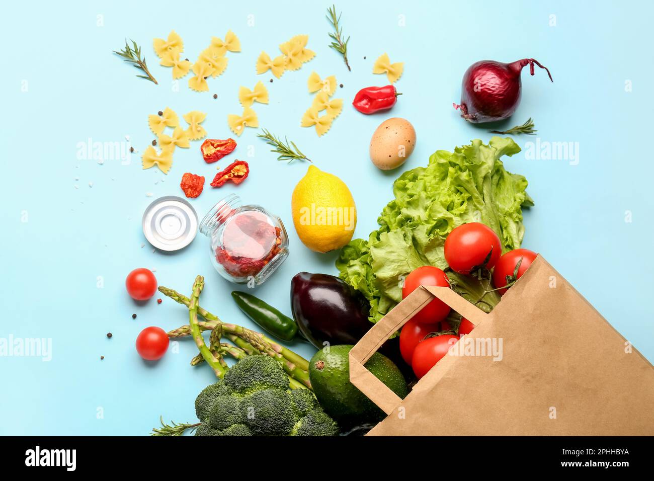 Paper bag with vegetables and fruits on light blue background Stock ...