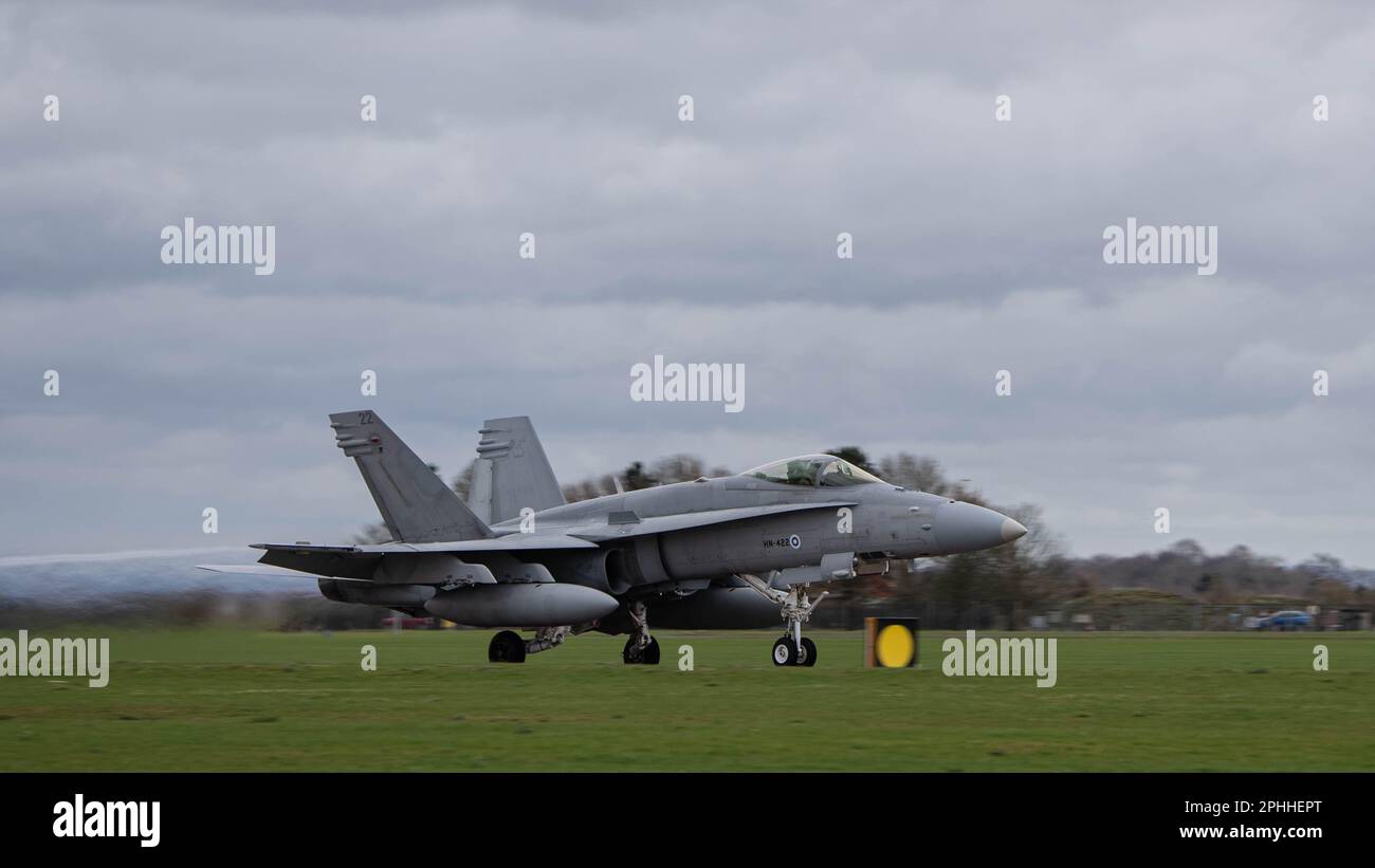 A Finnish Air Force F/A-18C Hornet takes-off at Royal Air Force Waddington, England, prior to a training mission during Exercise Cobra Warrior 23-1 March 21, 2023. Finland is among six other nations participating in this iteration of Cobra Warrior, increasing interoperability between NATO Allies and Partners. (U.S. Air Force photo by Airman 1st Class Austin Salazar)Wing. Stock Photo