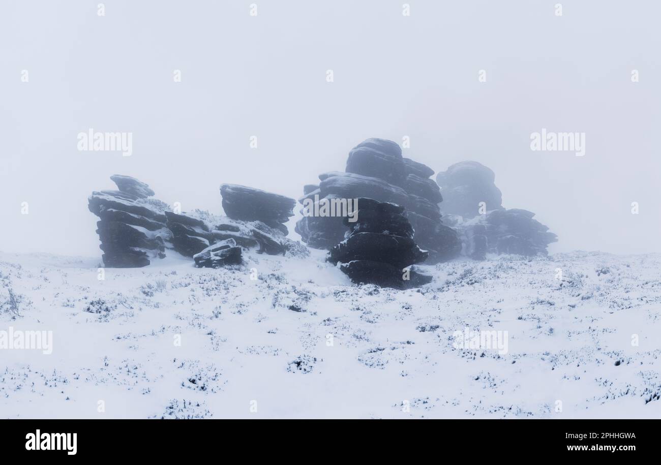 Winter snow, the Coach and Horses or Wheel Stones rock formations on Derwent Edge in the Peak District, up above Ladybower Reservoir Stock Photo