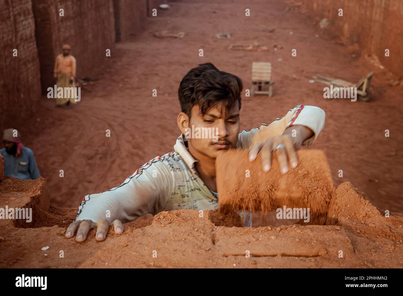 Worker unloading bricks at a brick kiln. In recent years, the number of ...