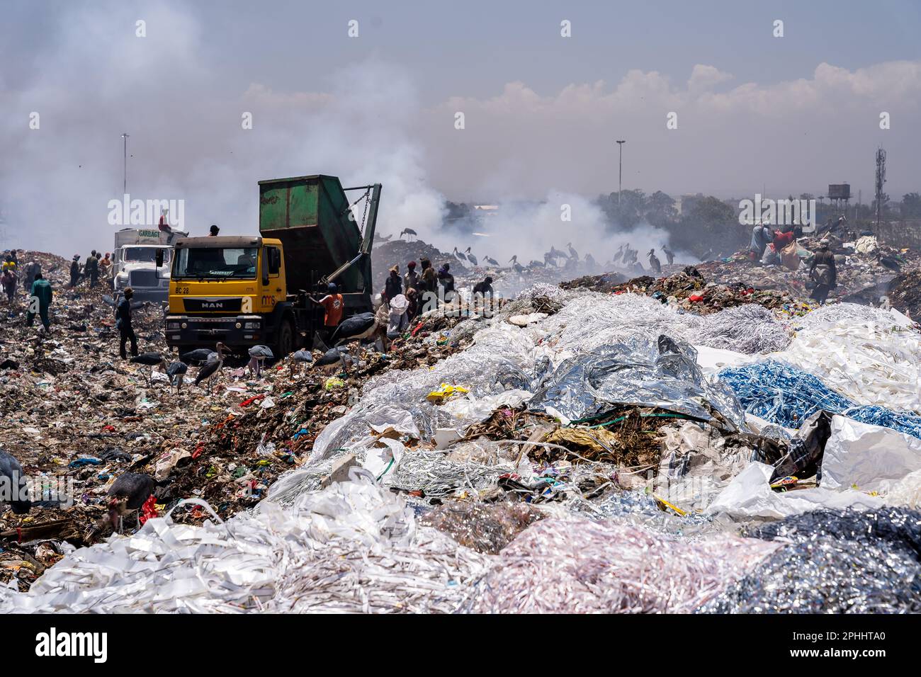 Nairobi, Kenya. 23rd Feb, 2023. People unloading trash from trucks at Dandora dumpsite. Dandora is the biggest dumpsite in East Africa and is the destination of the solid waste generated by Nairobi. It has been declared full in 1996 but is still operating and a lot of people, including children, go there looking for plastic, food or clothes they can sell. (Photo by Simone Boccaccio/SOPA Images/Sipa USA) Credit: Sipa US/Alamy Live News Stock Photo