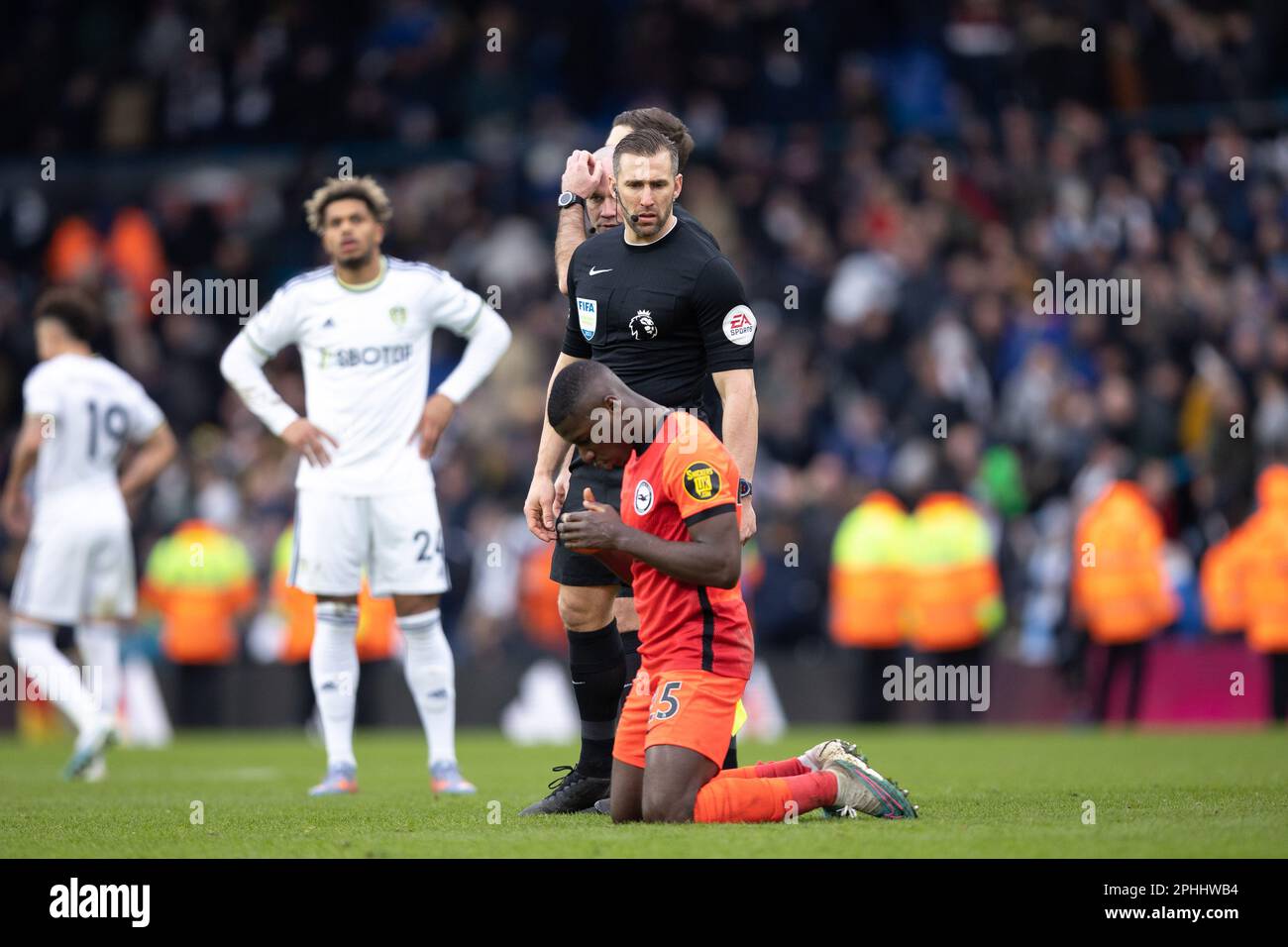 Paul Tierney, the match referee, watches as Moisés Caicedo of Brighton & Hove Albion genuflects during the Premier League match between Leeds United and Brighton & Hove Albion at Elland Road, Leeds on Sunday 12th March 2023. (Photo: Pat Scaasi | MI News) Credit: MI News & Sport /Alamy Live News Stock Photo
