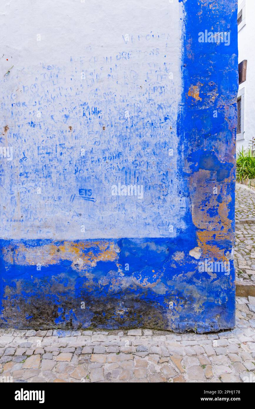 Europe, Portugal, Obidos. Blue graffiti of hand prints and names on a wall in Obidos. Stock Photo