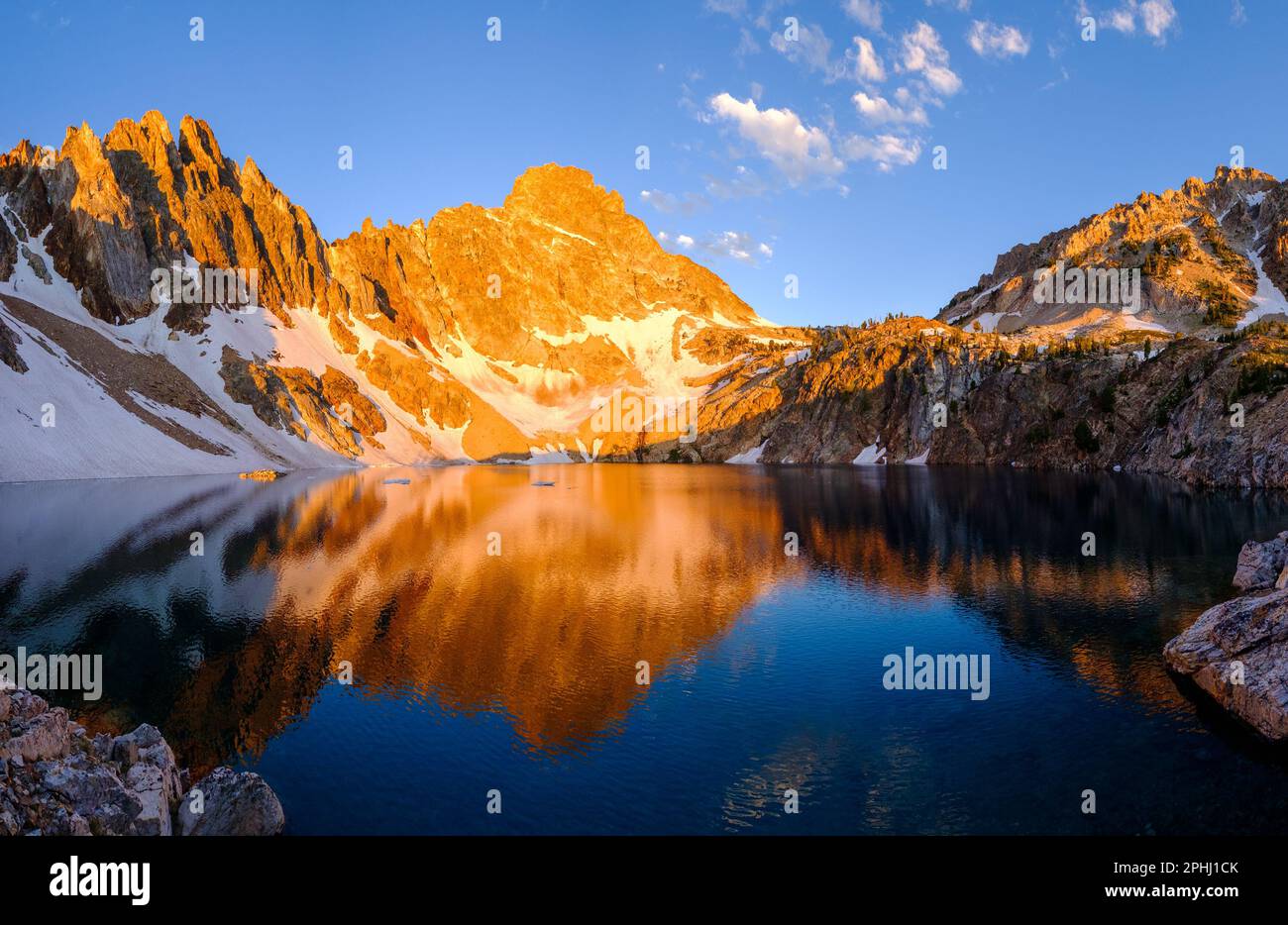 Sunrise Illuminates Thompson Peak Reflected in an Alpine Lake. Sawtooth