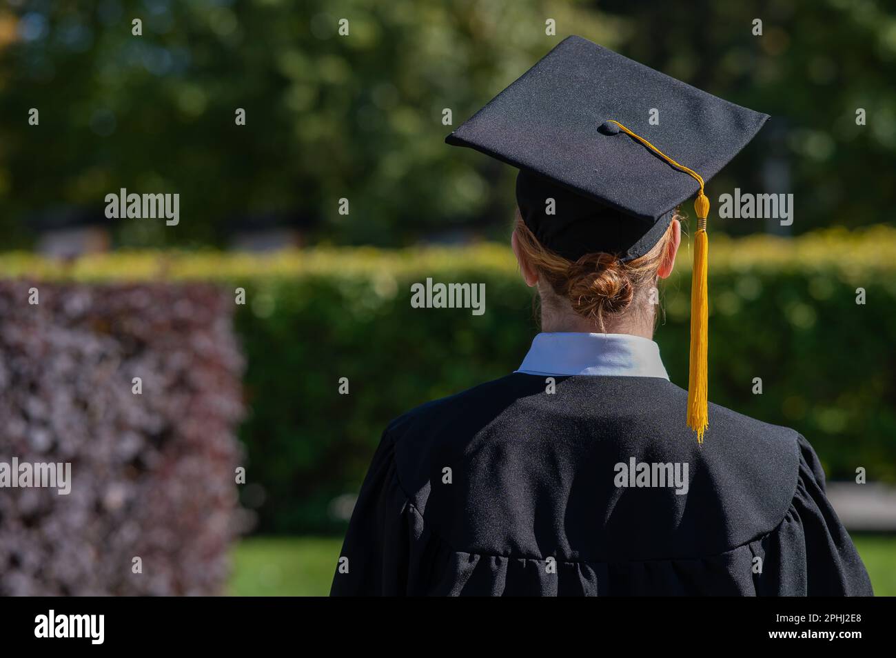 Woman in graduation gown stands hi-res stock photography and images - Alamy