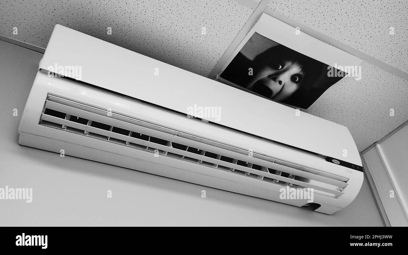 A photo of a screaming face on an office ceiling is humorously placed