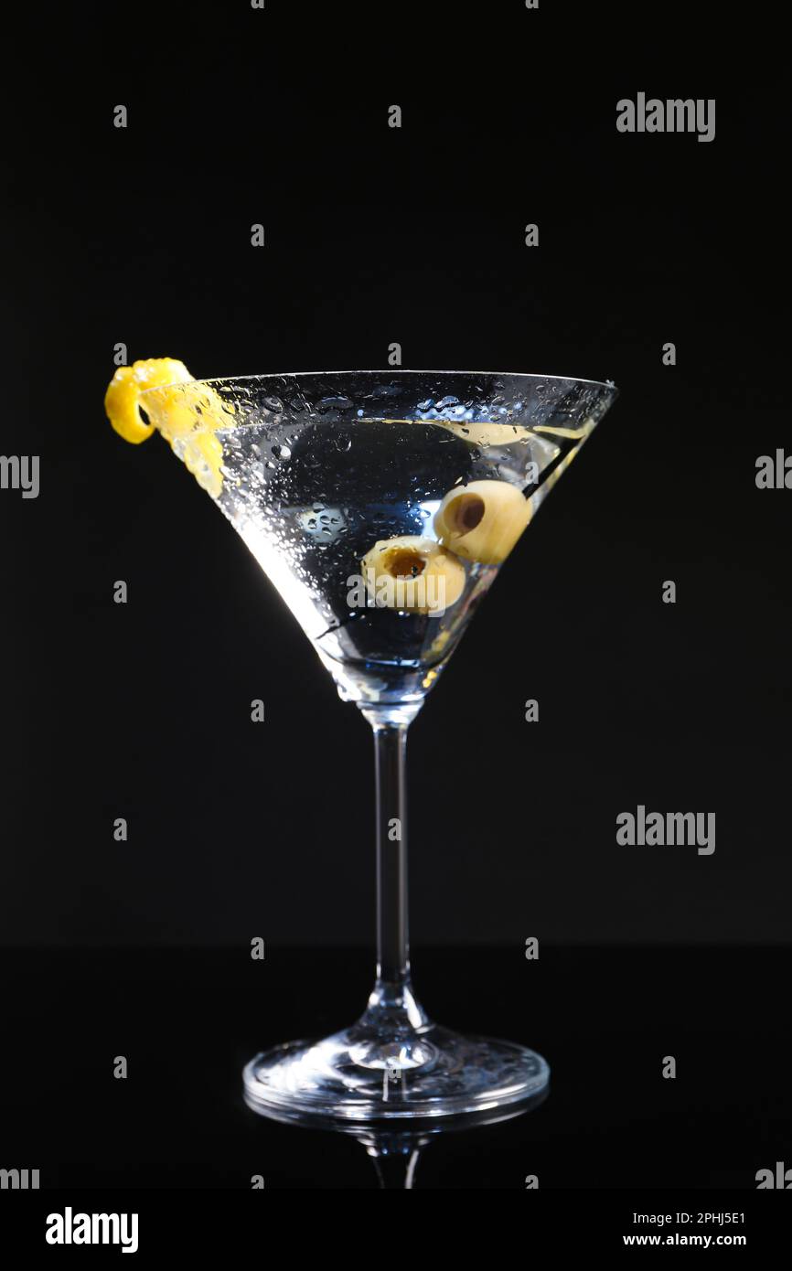 Martini cocktail with olives and lemon twist on dark background Stock Photo Alamy