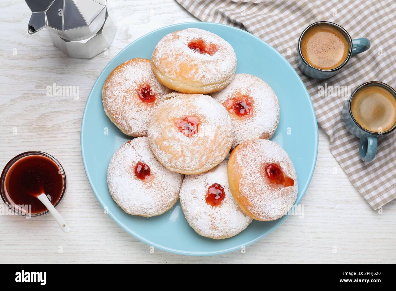Delicious jam donuts served with coffee on white wooden table, flat lay Stock Photo