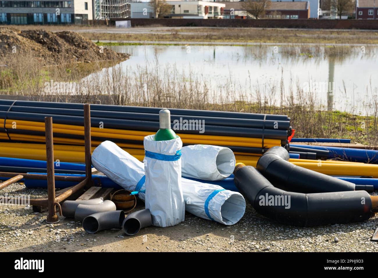 Construction site with pipes of different colors and sizes located on