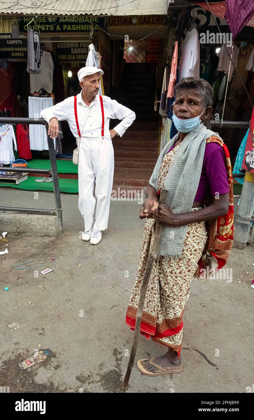 beggar woman near a pilgrim in Puttaparthi, India Stock Photo