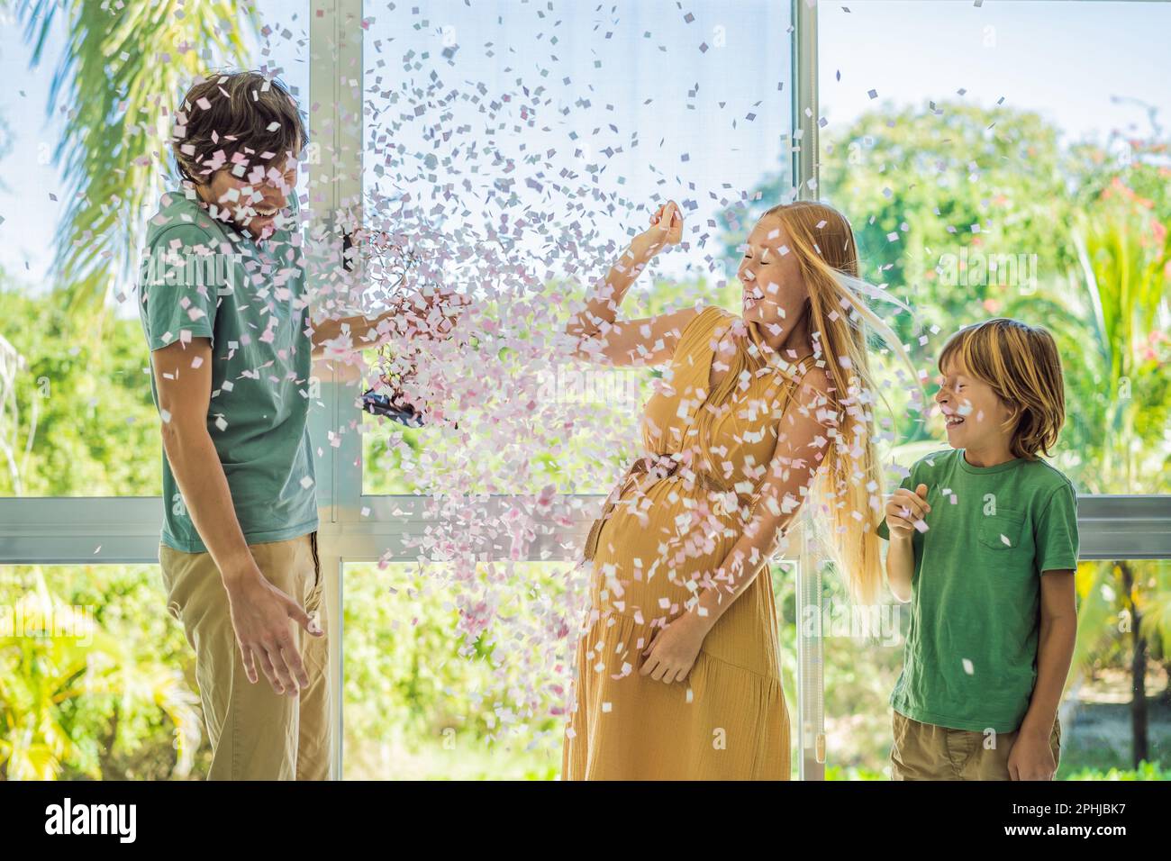 It's a girl. Expectant parents mother, father and their elder son are ...