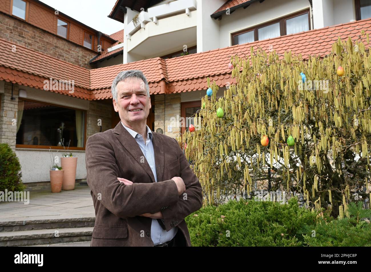 Waldeck, Germany. 22nd Mar, 2023. Christian Gerlach, owner of the Hotel Werbetal in the district of Nieder-Werbe, stands in front of the hotel entrance. Even before the Corona pandemic, the owner and his family equipped the 28 rooms of his hotel with tablets and Internet-enabled TVs. Bookings in the restaurant are thus possible at any time, and there is also a stable WLAN network on the terrace. (to dpa 'Are hotels and restaurants in Hesse being left behind digitally?') Credit: Uwe Zucchi/dpa/Alamy Live News Stock Photo