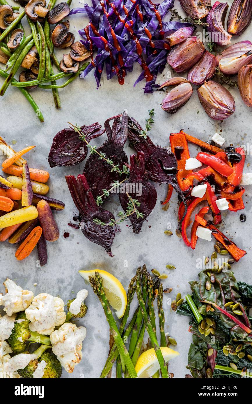Messy groups of roasted, steamed and sauteed vegetables on parchment