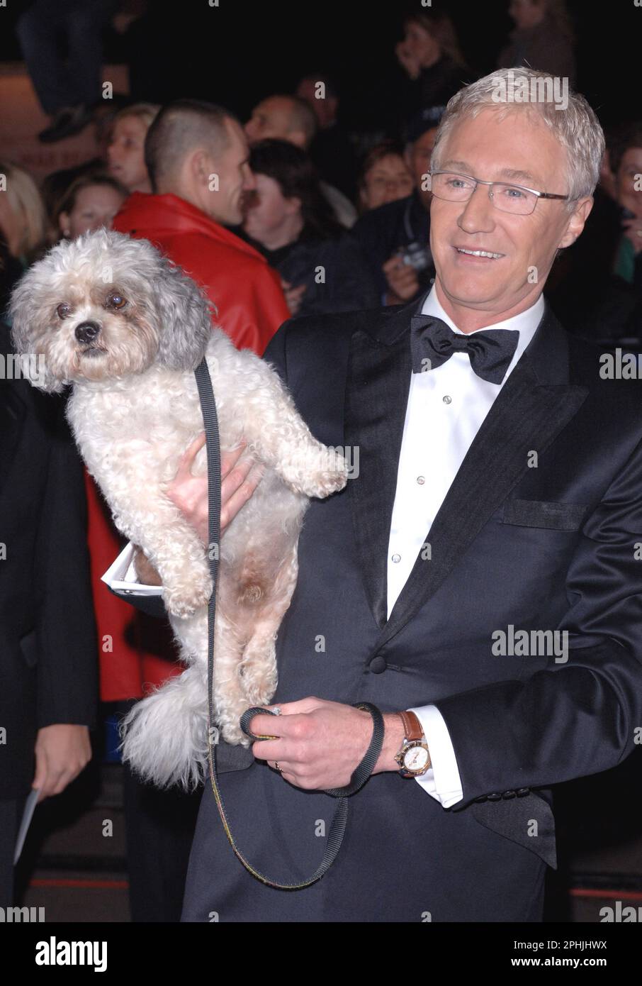 File photo dated 25/10/05 of Paul O'Grady and his dog Buster arriving for the National Television Awards 2005 (NTA), at the Royal Albert Hall, central London. TV presenter and comedian Paul O'Grady has died at the age of 67, his partner Andre Portasio has said. The TV star, also known for his drag queen persona Lily Savage, died 'unexpectedly but peacefully' on Tuesday evening, a statement shared with the PA news agency via a representative said. Issue date: Wednesday March 29, 2023. Stock Photo