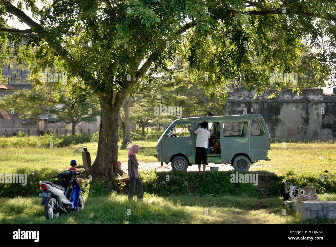 A motorcycle and a minibus are parked by visitors near Fort Speelwijk, one of the cultural heritage objects in area now called Banten Lama (Old Banten) in Serang, Banten, Indonesia, on this photo taken in 2010. 'The sustainability of cultural heritage is strongly linked to the effective participation of local communities in the conservation and management of these resources,' according to a team of scientists led by Sunday Oladipo Oladeji in their research article published on Sage Journals on October 28, 2022. Banten Lama (Old Banten) area was a part of the important port of Banten Sultanate, Stock Photo
