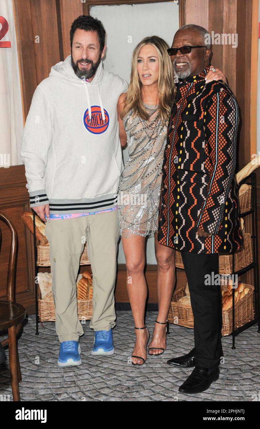 Los Angeles, USA. 28th Mar, 2023. MURDER MYSTERY 2 Cast & Crew - (Standing,  L-R) Jason Young, Ori Marmur, Zurin Villanueva, Ted Sarandos, Jodie  Turner-Smith, Adam Sandler, Scott Stuber, Jennifer Aniston, Jeremy