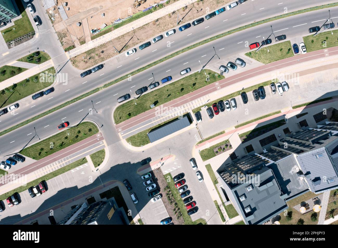 aerial top view of urban streets, road intersections, parking lots and buildings at sunny summer morning Stock Photo