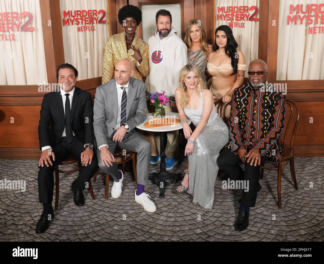 Los Angeles, USA. 28th Mar, 2023. (L-R) MURDER MYSTERY 2 Cast - Enrique Arce, Jodie Turner-Smith, Mark Strong, Adam Sandler, Jennifer Aniston, Mélanie Laurent, Kuhoo Verma and Dr. John Kani at the Netflix's MURDER MYSTERY 2 Los Angeles Premiere held at the Regency Village Theater in Westwood, CA on Tuesday, ?March 28, 2023. (Photo By Sthanlee B. Mirador/Sipa USA) Credit: Sipa USA/Alamy Live News Stock Photo