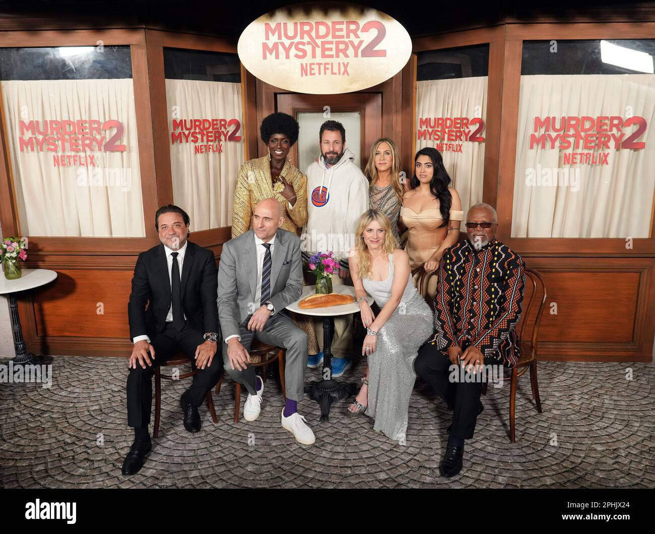 Los Angeles, USA. 28th Mar, 2023. (L-R) MURDER MYSTERY 2 Cast - Enrique Arce, Jodie Turner-Smith, Mark Strong, Adam Sandler, Jennifer Aniston, Mélanie Laurent, Kuhoo Verma and Dr. John Kani at the Netflix's MURDER MYSTERY 2 Los Angeles Premiere held at the Regency Village Theater in Westwood, CA on Tuesday, ?March 28, 2023. (Photo By Sthanlee B. Mirador/Sipa USA) Credit: Sipa USA/Alamy Live News Stock Photo