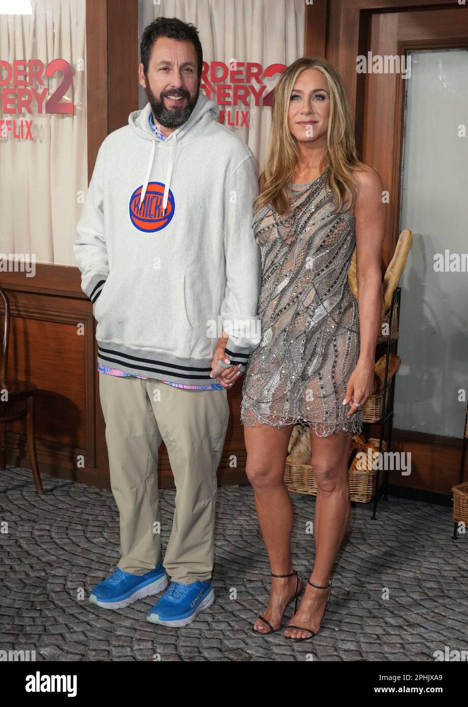 Adam Sandler, left, and Jennifer Aniston arrive at the premiere of