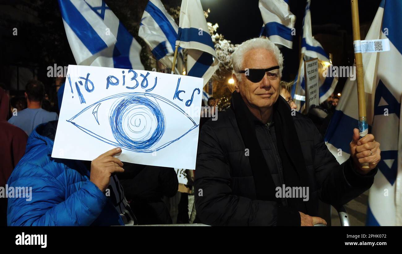 JERUSALEM, ISRAEL - MARCH 28: A protester holds a sign which reads 'We will not turn a blind eye' as anti government protesters chant slogans during a demonstration outside the President's Residence against negotiations between members of the government and opposition on Judicial overhaul on March 28, 2023 in Jerusalem, Israel. Credit: Eddie Gerald/Alamy Live News Stock Photo