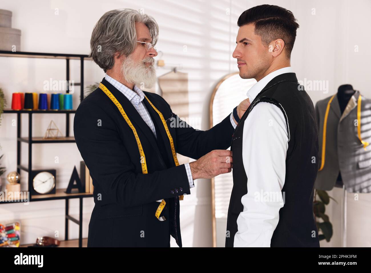 Mature tailor measuring client hi-res stock photography and images - Alamy