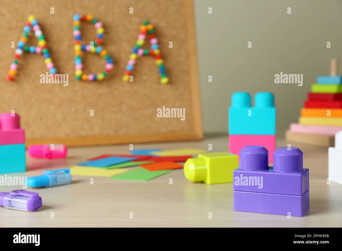 Cork board with abbreviation ABA (Applied behavior analysis) at table