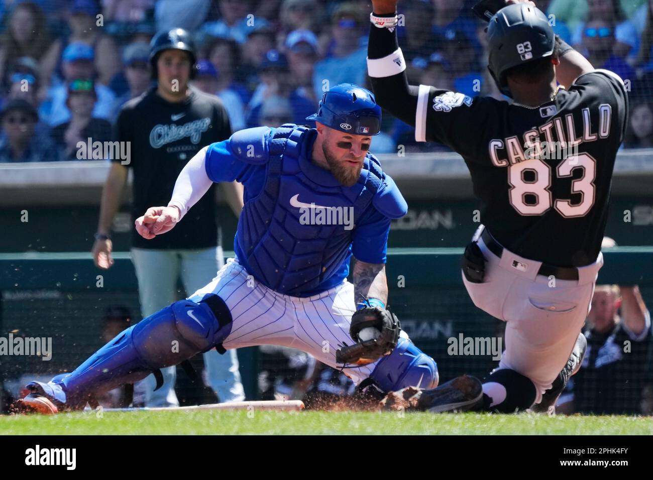 Chicago Cubs catcher Tucker Barnhart, left, tags out Chicago White Sox's  Moises Castillo (83) trying to score a run during the second inning of a  spring training baseball game Tuesday, March 28
