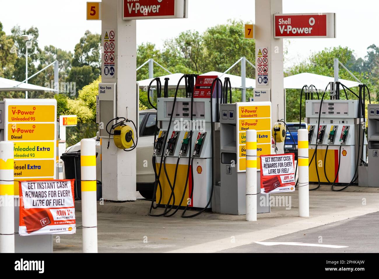 Shell petrol pumps or fuel pumps on the forecourt of a petrol station with cars filling up in South Africa Stock Photo