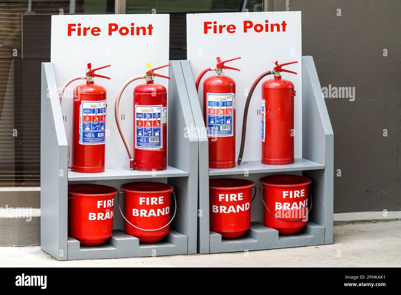 fire point with fire hydrants or extinguishers and red fire buckets at a petrol station for emergency use in South Africa concept fire equipment Stock Photo