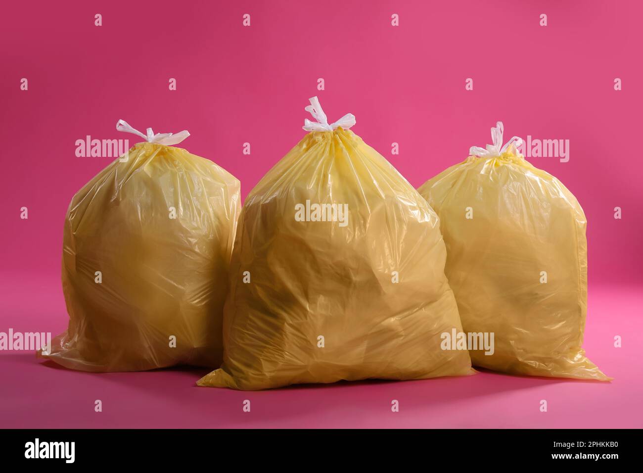 https://c8.alamy.com/comp/2PHKKB0/trash-bags-full-of-garbage-on-pink-background-2PHKKB0.jpg