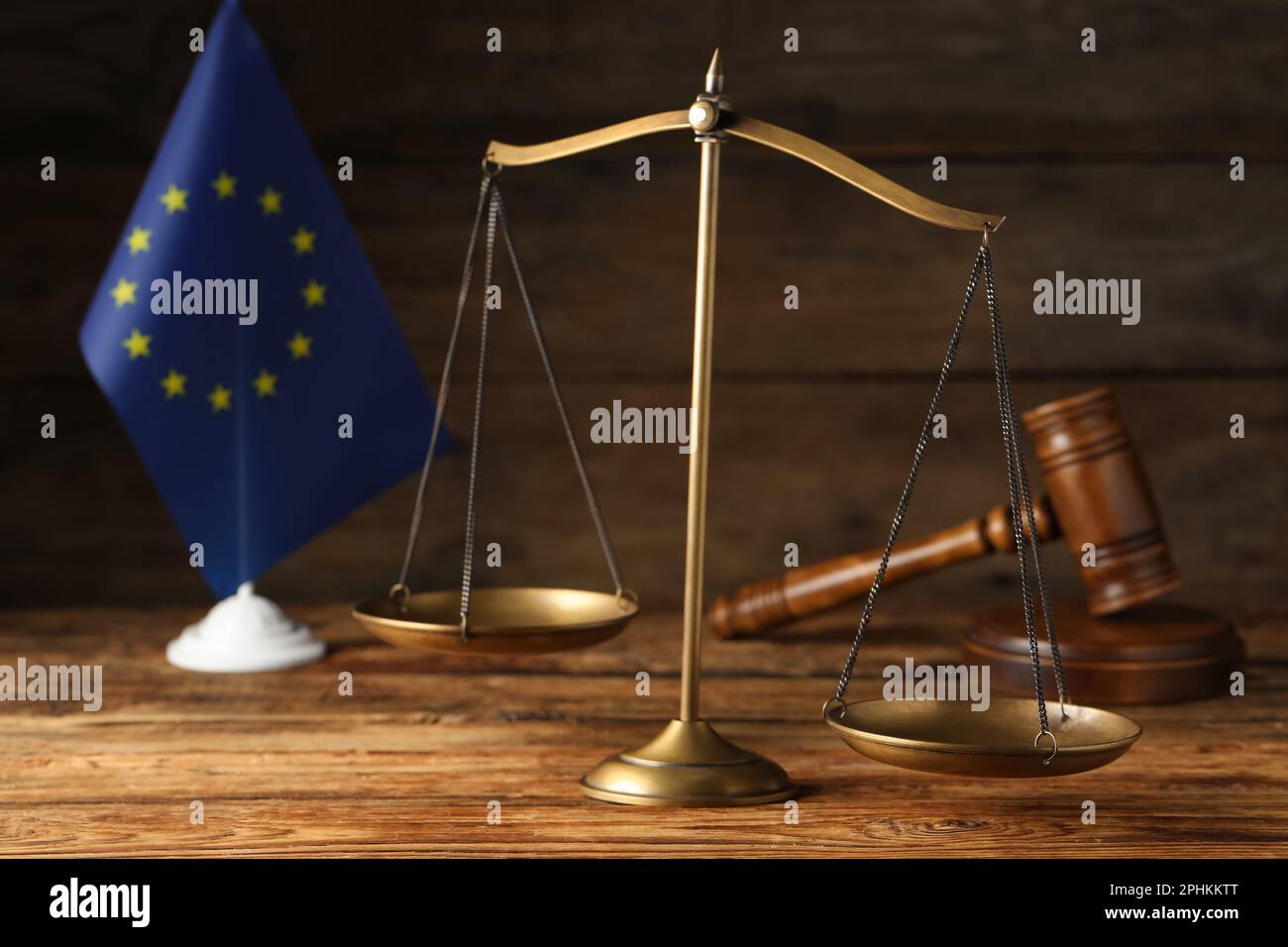 Scales of justice, judge's gavel and European Union flag on wooden ...