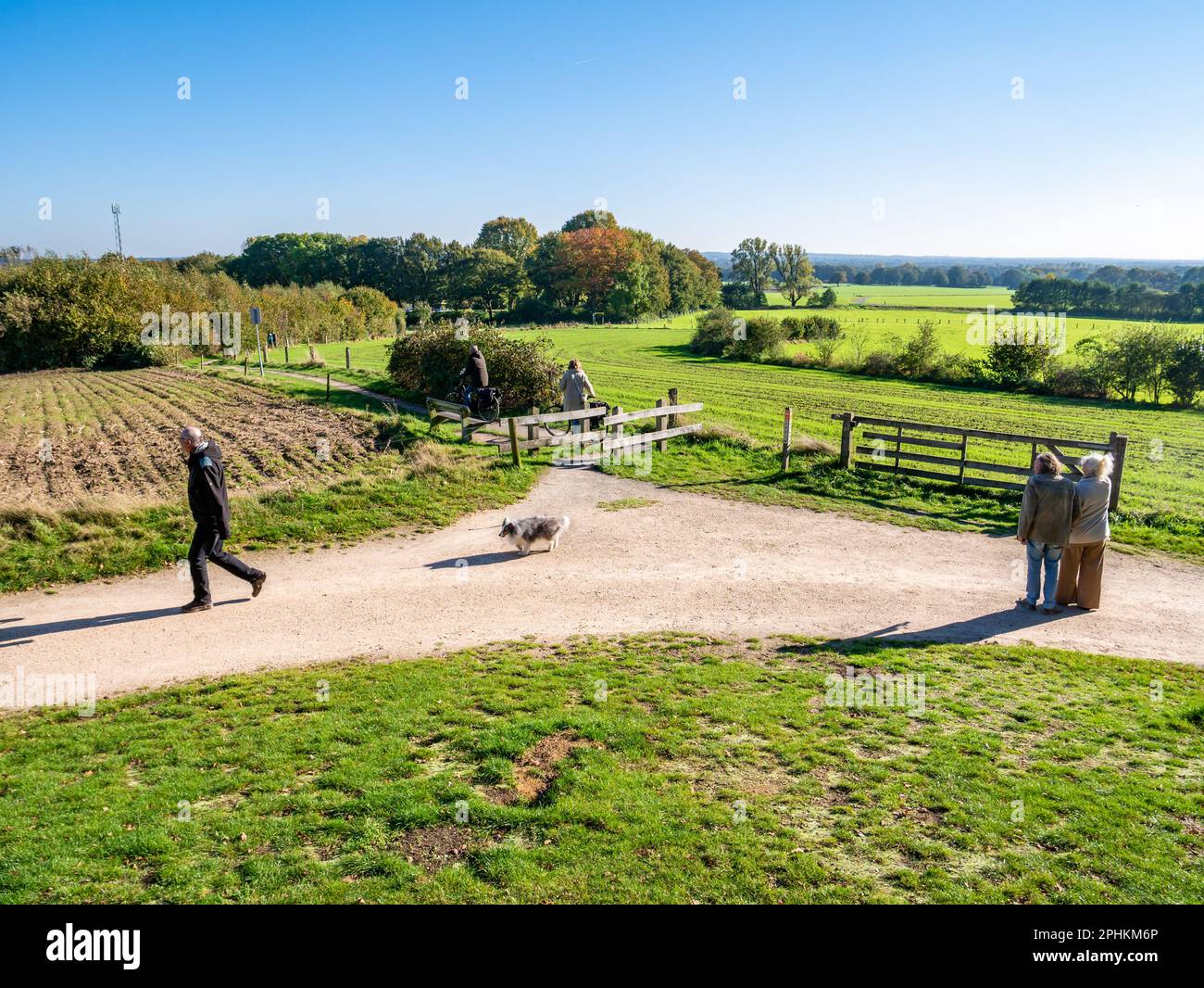 Senior couple, man walking dog and bicyclists on Kuiperberg near Ootmarsum, Overijssel, Netherlands Stock Photo