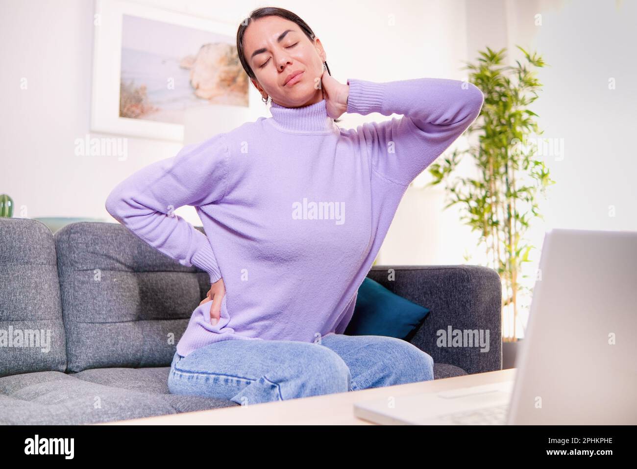 Woman suffering backache and pain caused by poor posture ergonomics