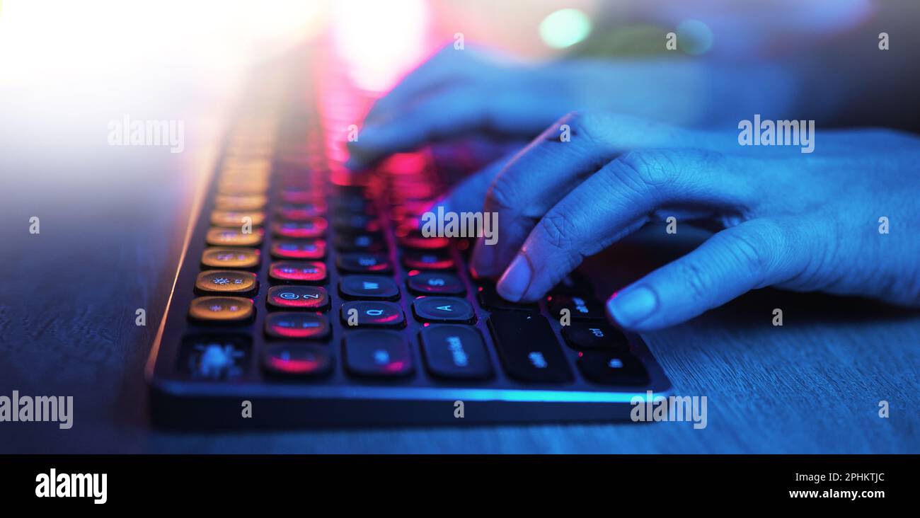 Hacker, hands and typing on neon keyboard for software, programming or cybersecurity. Developer, it coder and woman on computer keypad for hacking Stock Photo