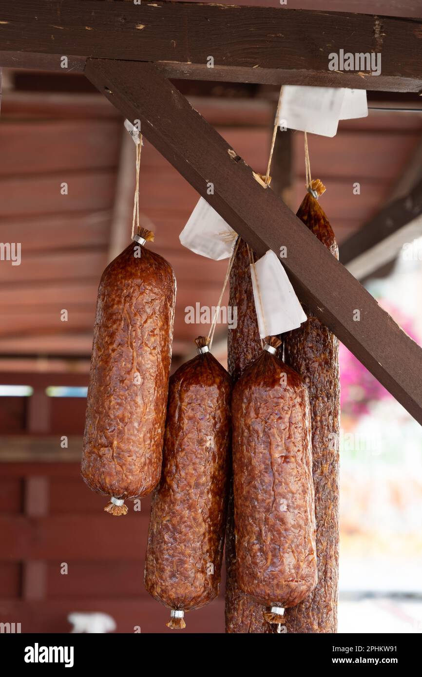 Hanging Smoked Sausage, Dried Salami, Chorizo, Wurst, Poland Kielbasa, Frankfurt Sausage, Longaniza on Village Market Stock Photo