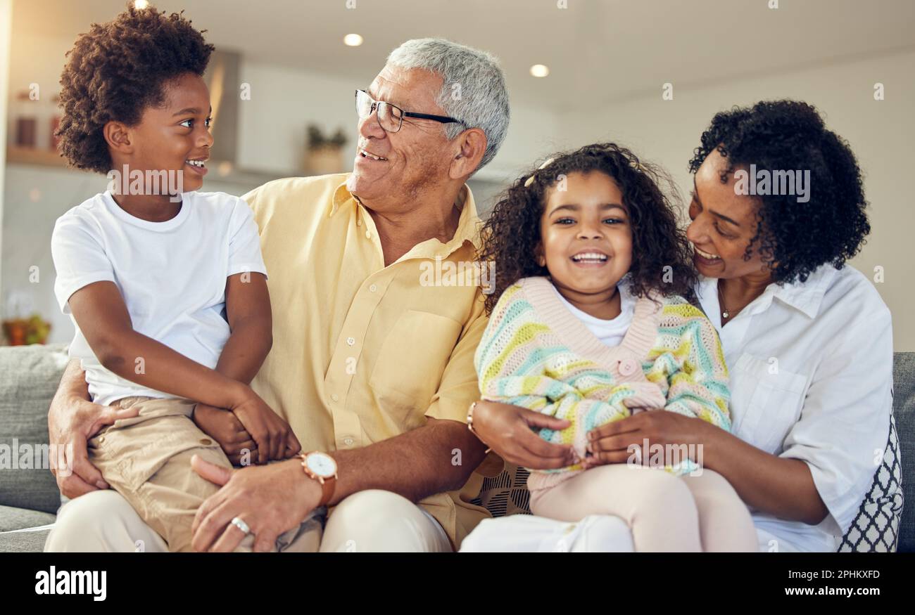 Family, love and grandparents with children on sofa in living room for playing, bonding and quality time. Love, home and happy grandfather, grandma Stock Photo