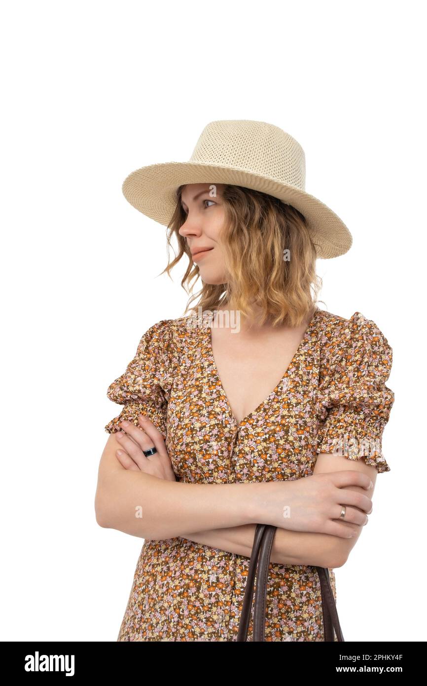 Contented pretty mature 40 year old woman in hat and dress isolated on white background. Stock Photo
