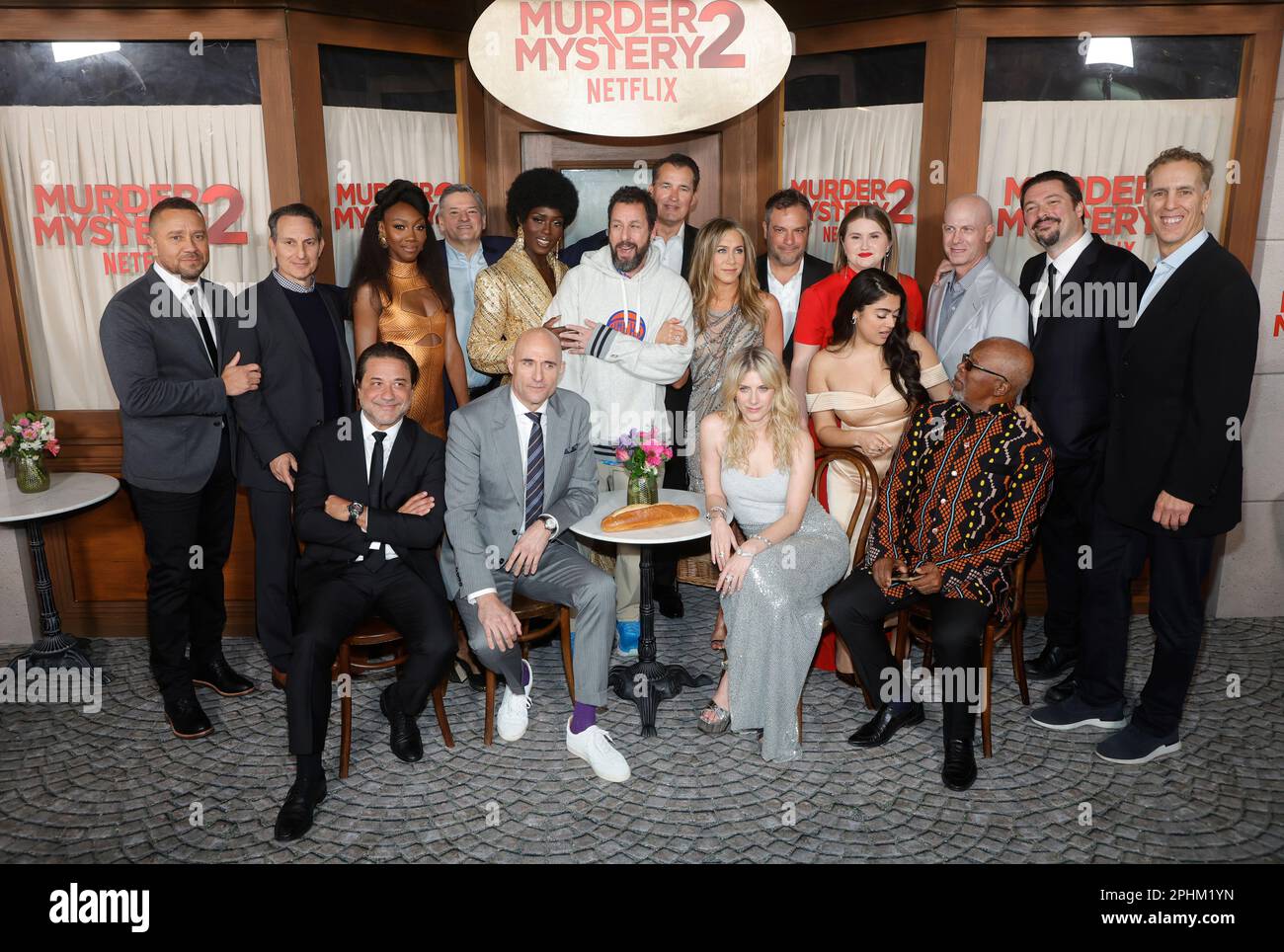 Los Angeles, USA. 28th Mar, 2023. MURDER MYSTERY 2 Cast & Crew - (Standing,  L-R) Jason Young, Ori Marmur, Zurin Villanueva, Ted Sarandos, Jodie  Turner-Smith, Adam Sandler, Scott Stuber, Jennifer Aniston, Jeremy