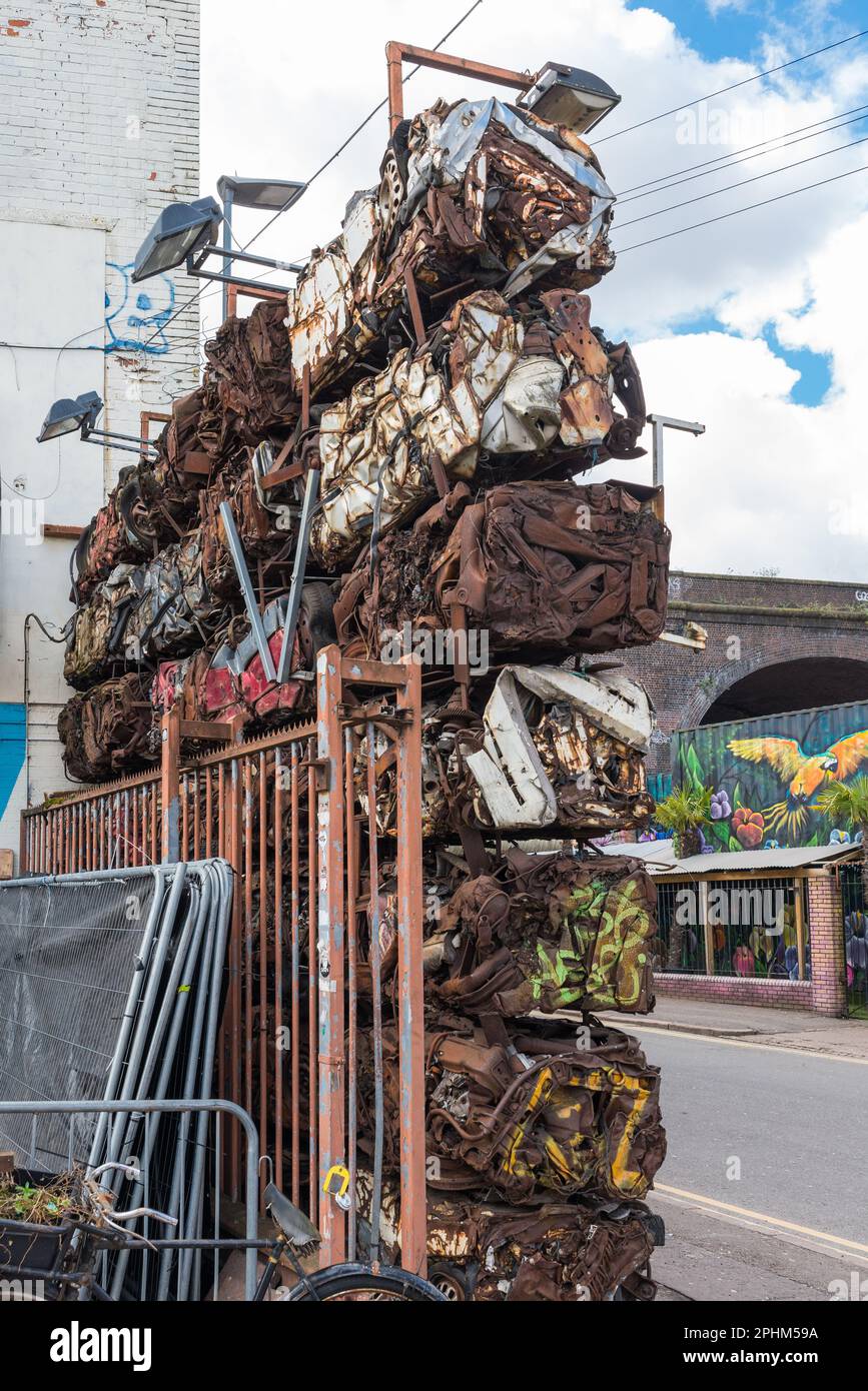Crushed cars used to form a wall in Digbeth in Birmingham Stock Photo