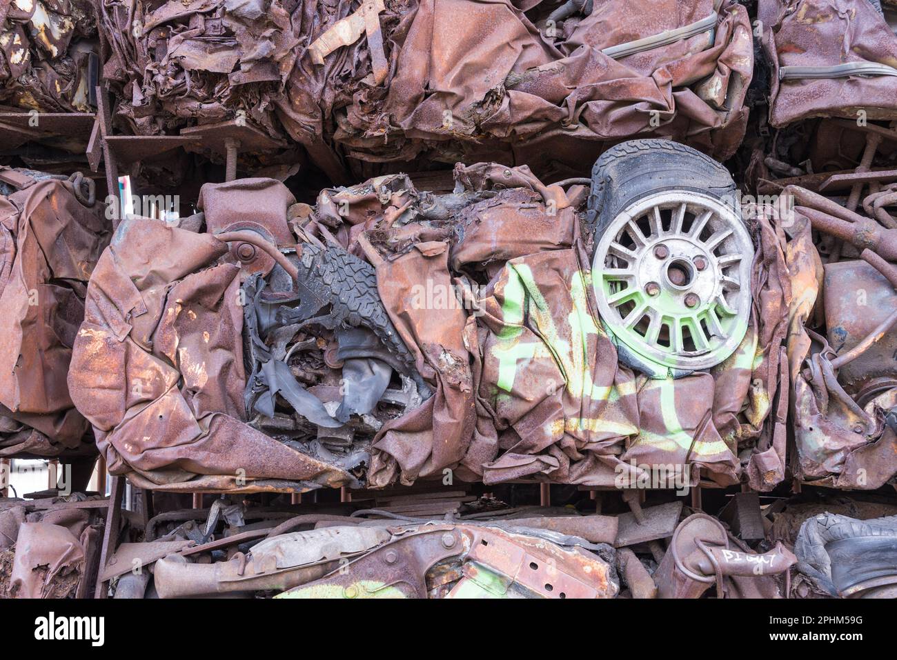 Crushed cars used to form a wall in Digbeth in Birmingham Stock Photo