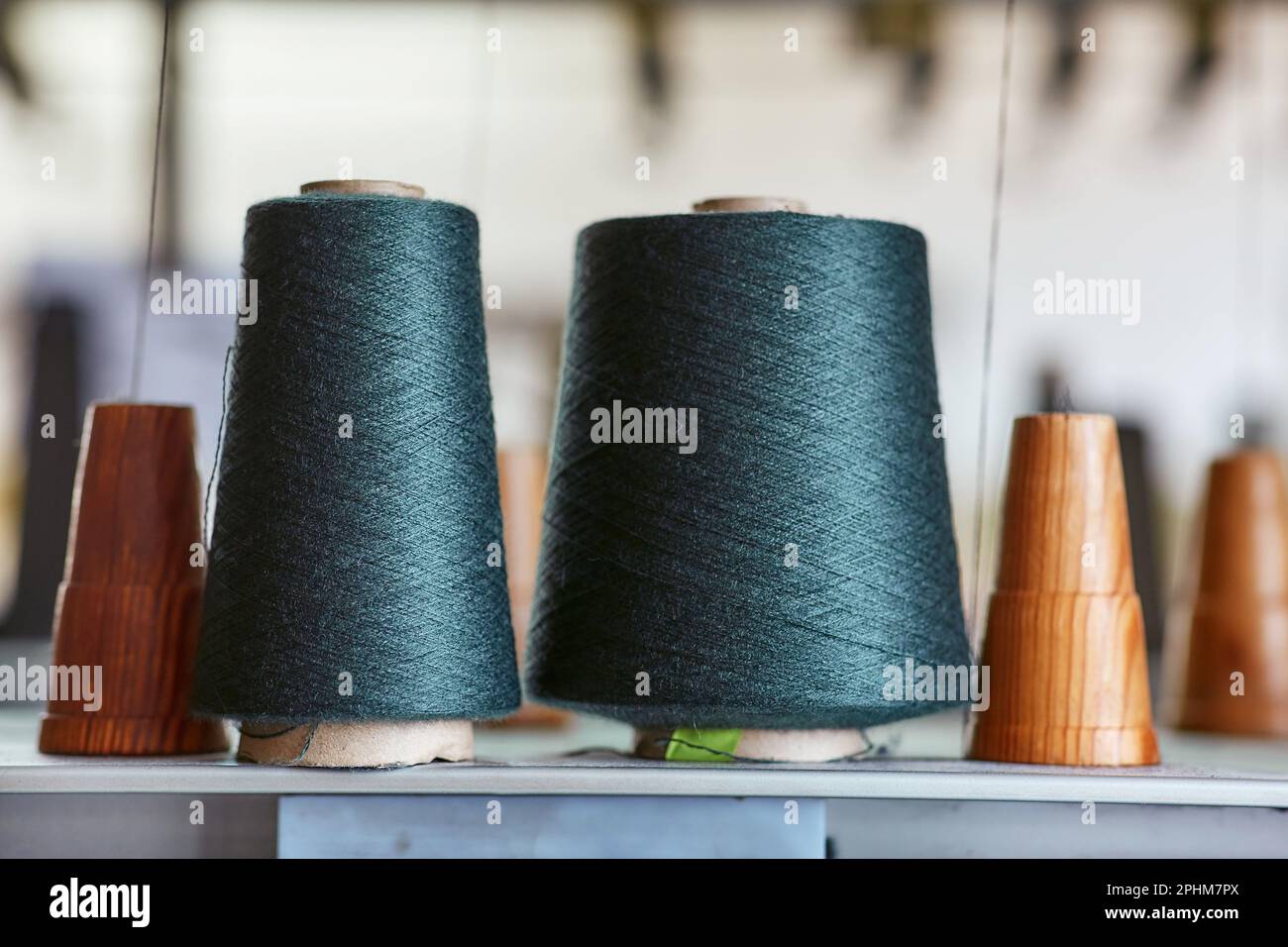 Two bobbins with industrial threads on cones Stock Photo