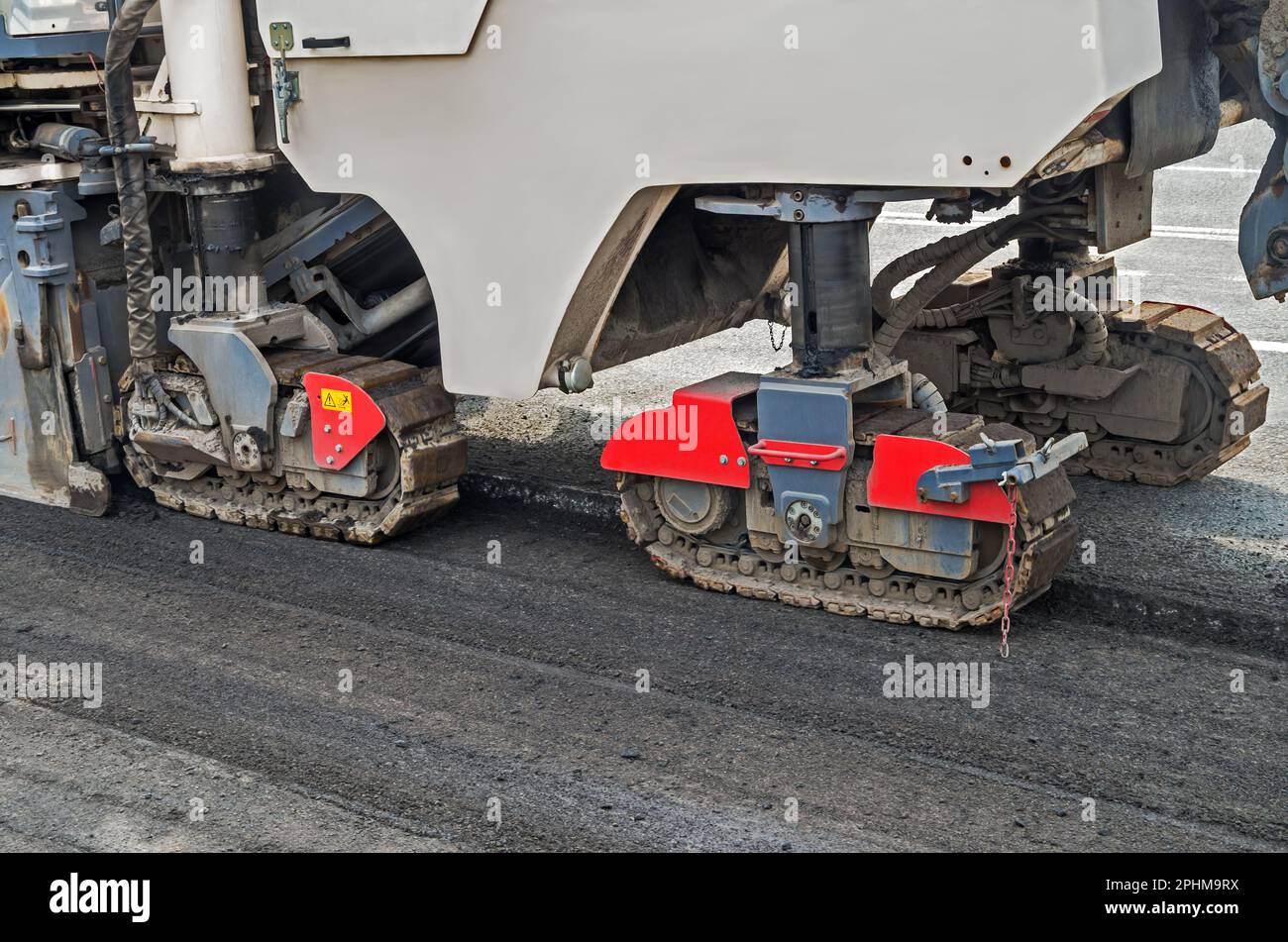 Road milling machine in real work of preparing the asphalt pavement for