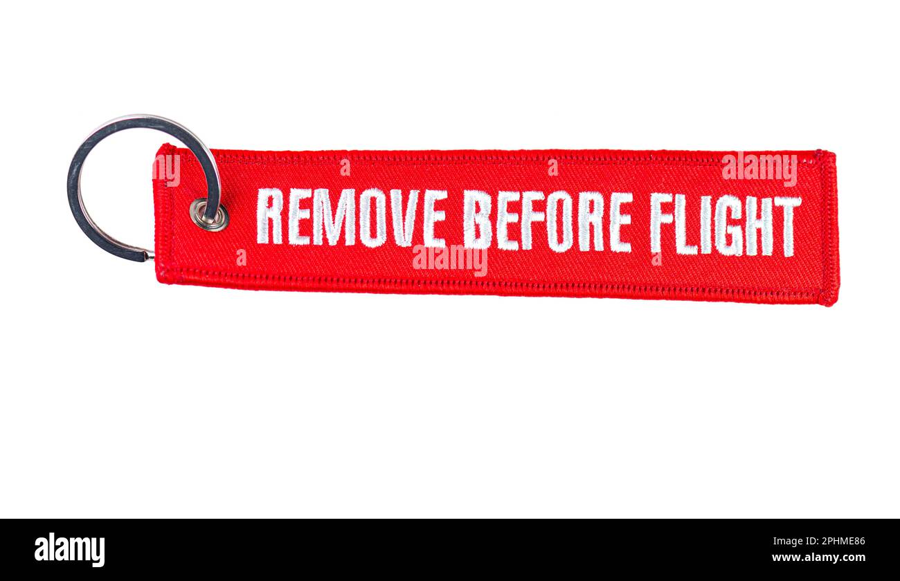 Trinket Remove before flight - warning tag. It is a safety warning seen on removable aircraft Stock Photo