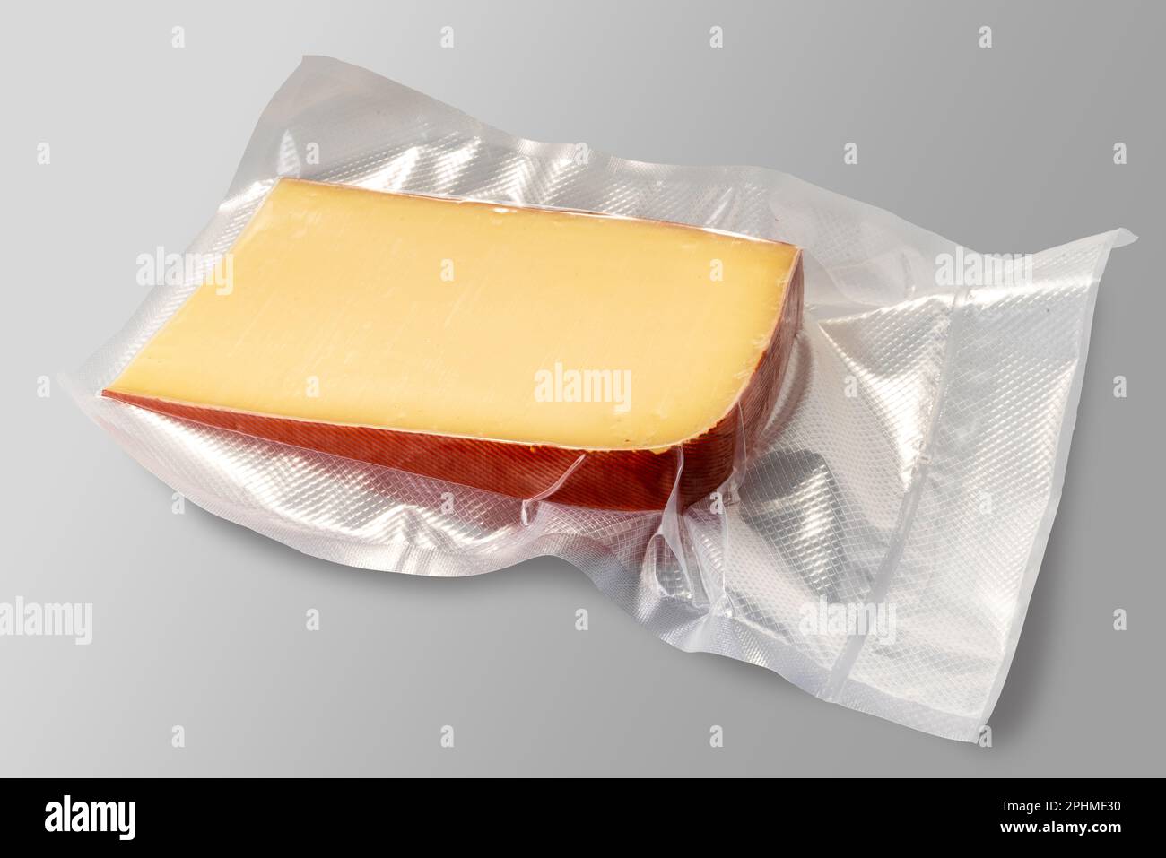 Fontal  cheese slice in vacuum pack for sous vide cooking isolated on gray background with clipping path included.clipping path included. Stock Photo