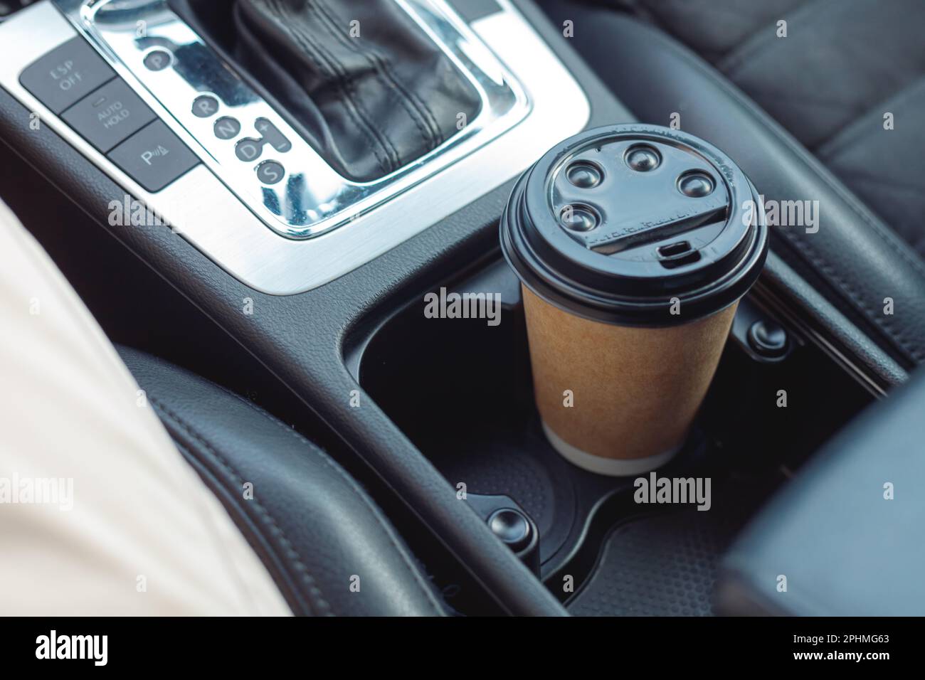Paper Cup in the cup holder in the car. Cup holder. A hot drink to